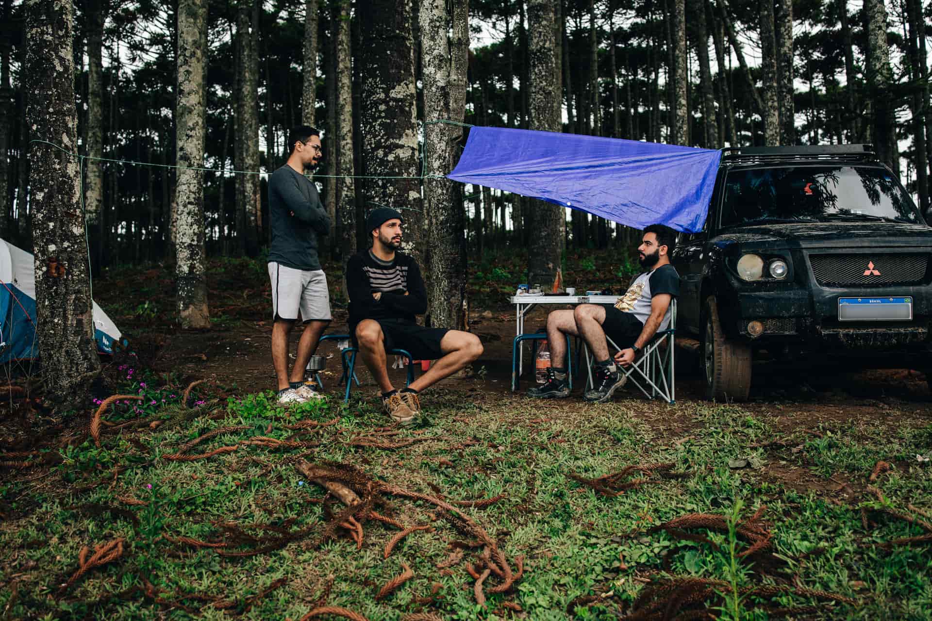 Hunting and camp gear laid out in a forest clearing